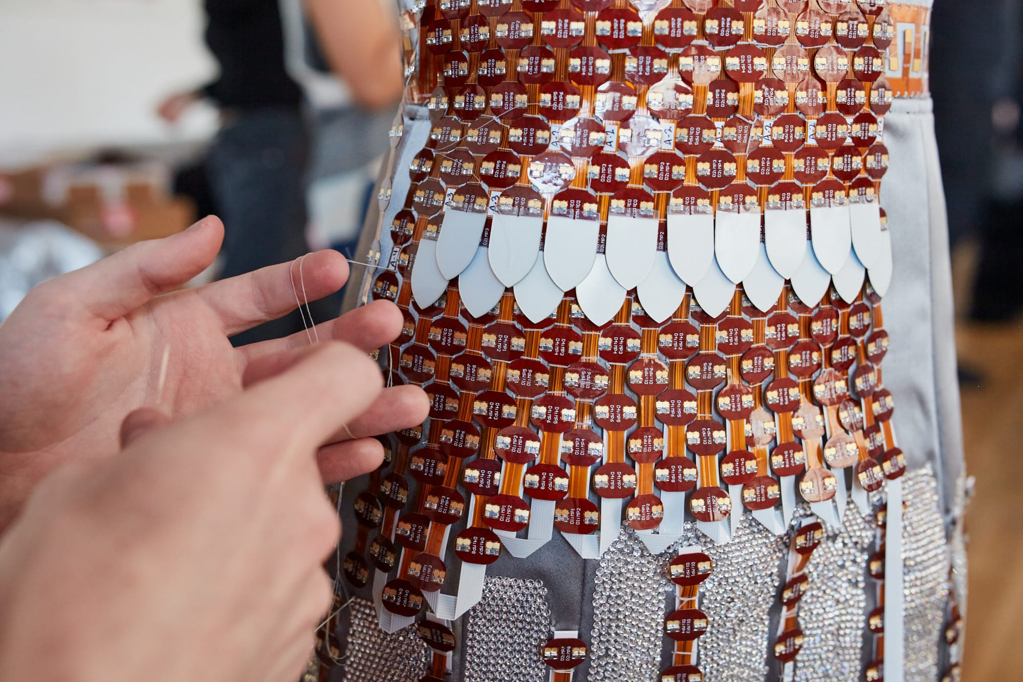 Close up on the Primrose Technology circuitry being applied to a dress.