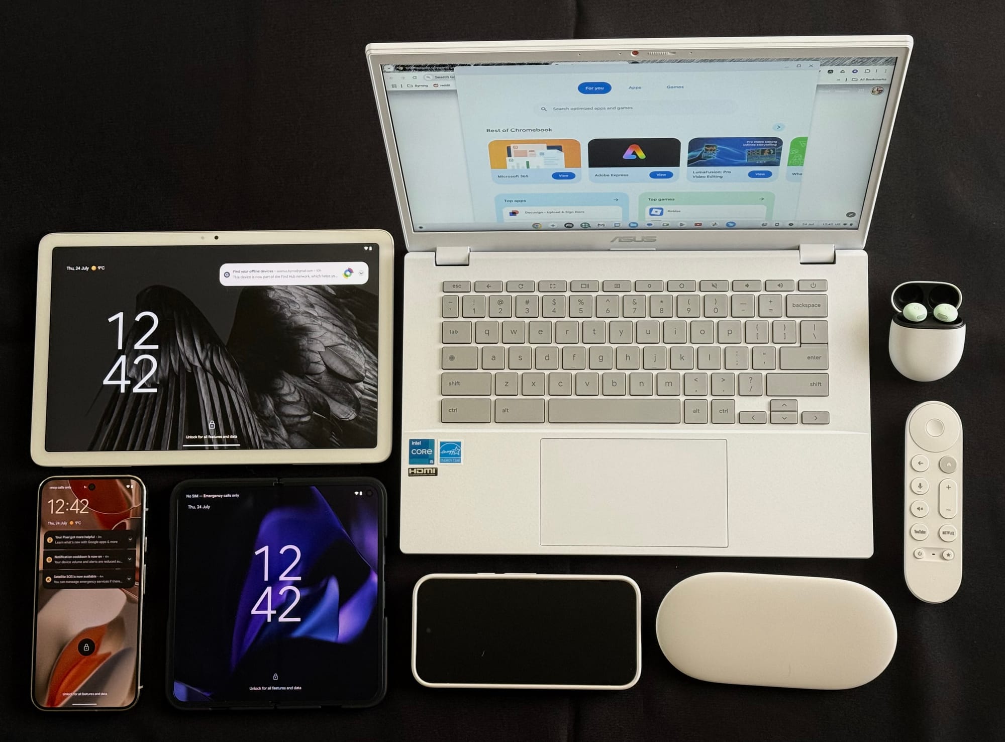 A top down image of the mentioned devices laid out in a grid on a black table.