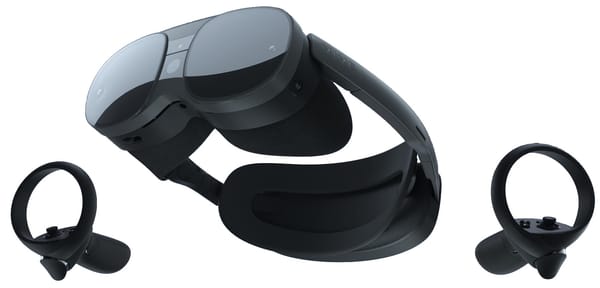 The VR headset and pair of controllers floating on a white background.