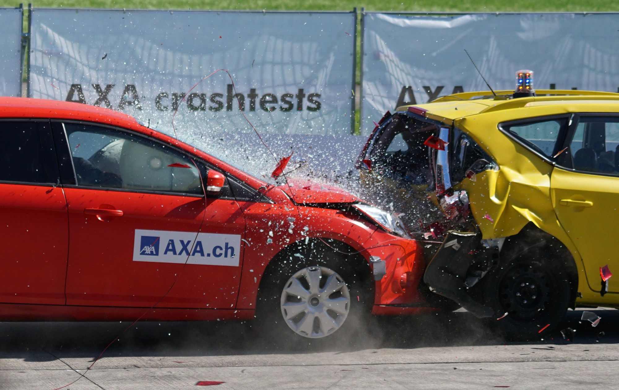 a red car crashing into a yellow car