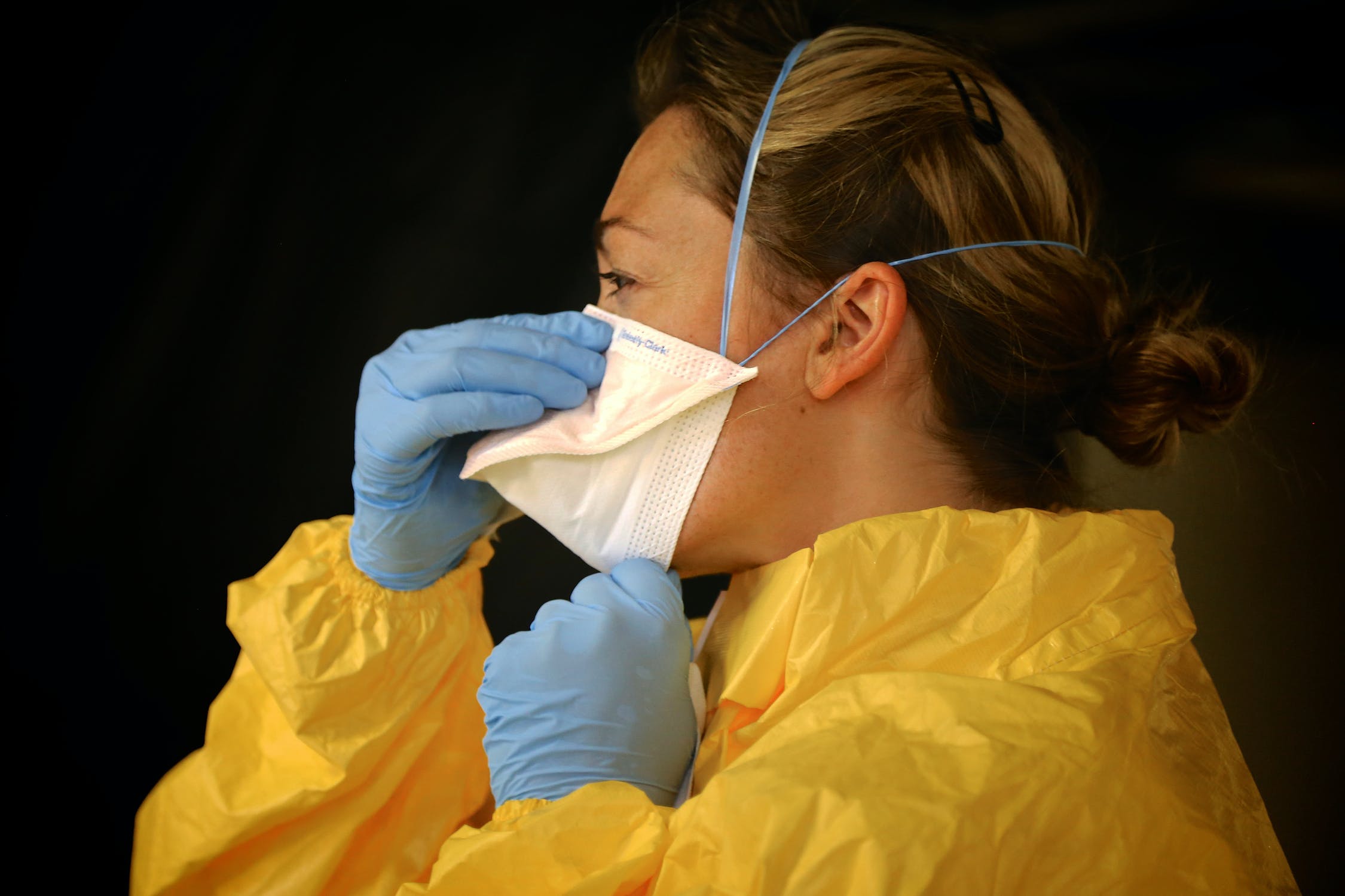 Woman putting on PPE